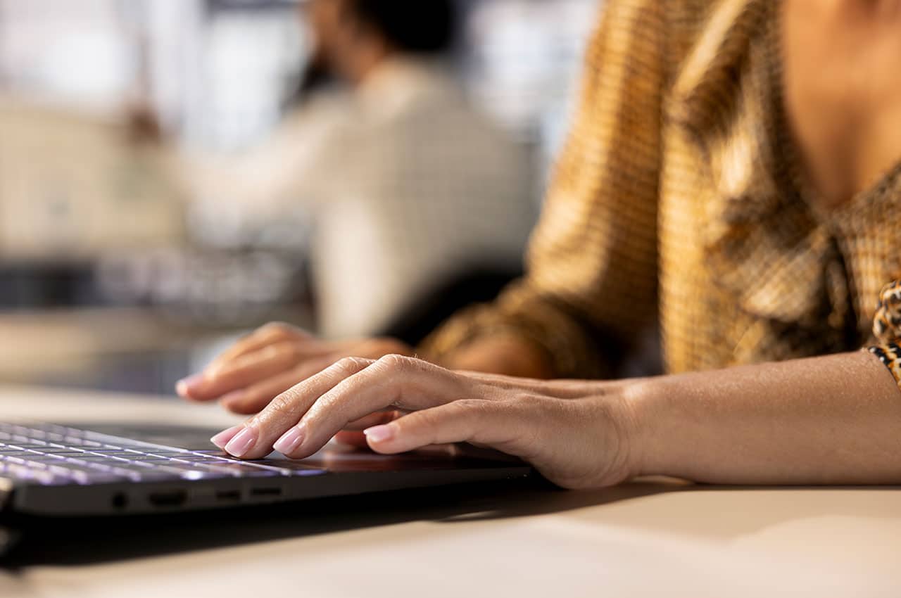 A woman typing on a keyboard